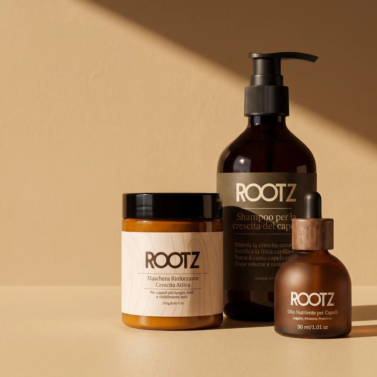 Shampoo, maschera e olio ROOTZ affiancati su un fondo chiaro